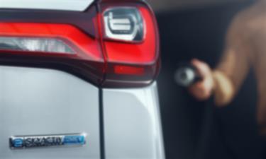 Driver approaches Mazda with level 2 charger in hand.