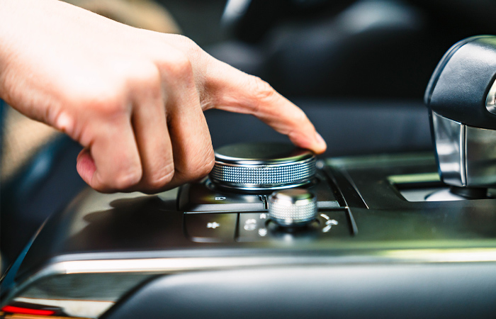 Driver adjusts HMI Command controls on center console.