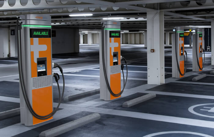 Two pairs of orange and white public chargers side by side.  